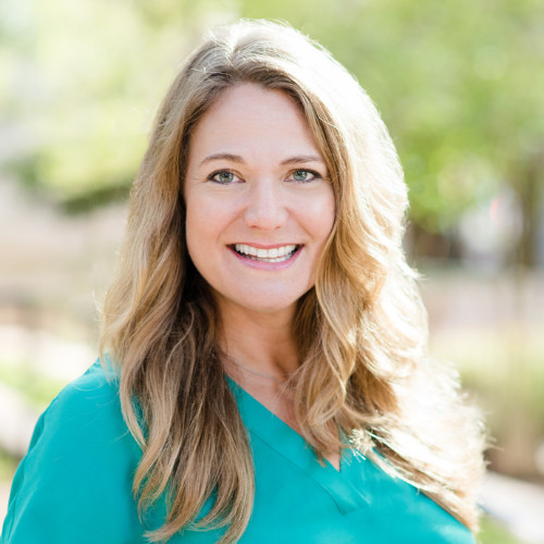 Wendy Covey has long blonde hair and is wearing a teal blouse.