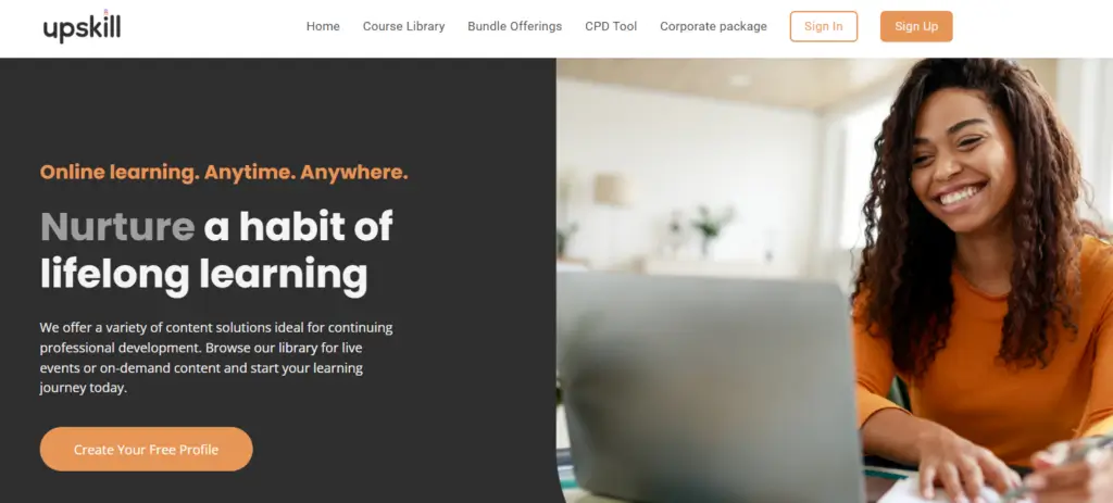 A screenshot of Upskill's website featuring the above-the-fold section that shows a smiling woman wearing an orange t-shirt using a laptop.