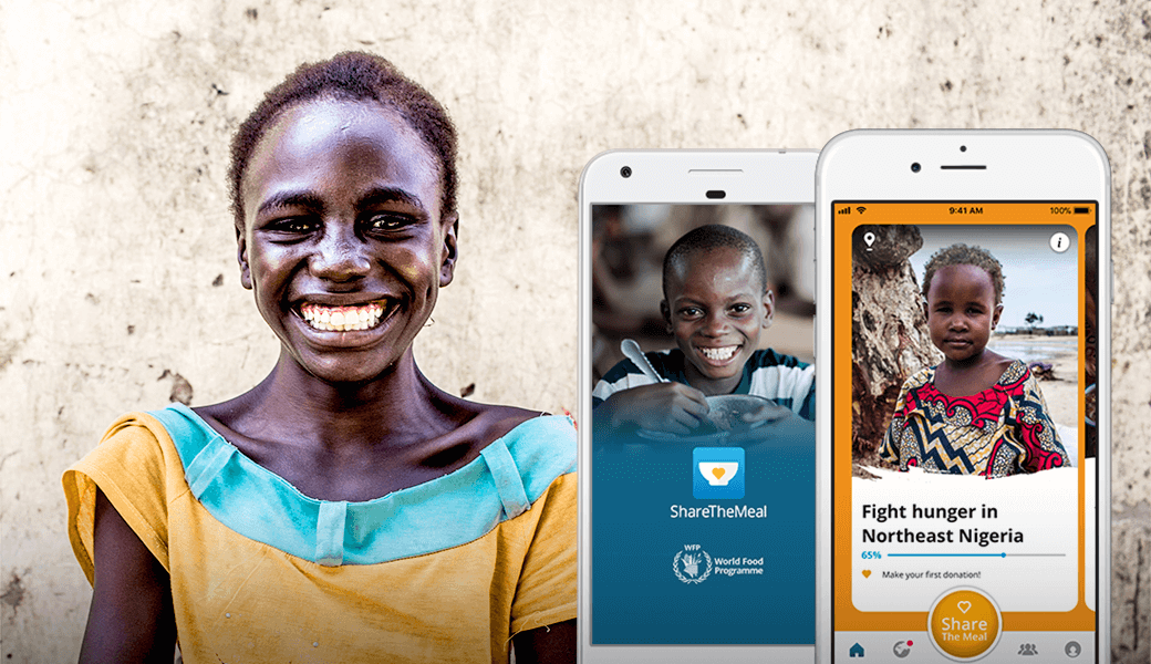 A screenshot showing a Nigerian child smiling, along with two mobile screens featuring other two Nigerian children in an ad promoting ShareTheMeal's mobile app.