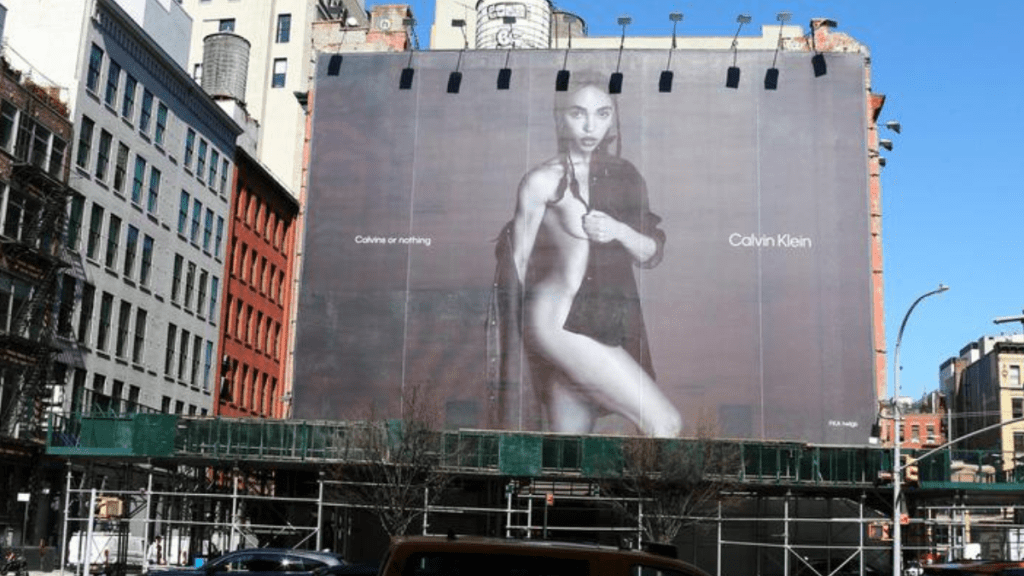 Billboard on the side of a building showing FKA Twigs wearing a Calvin Klein shirt