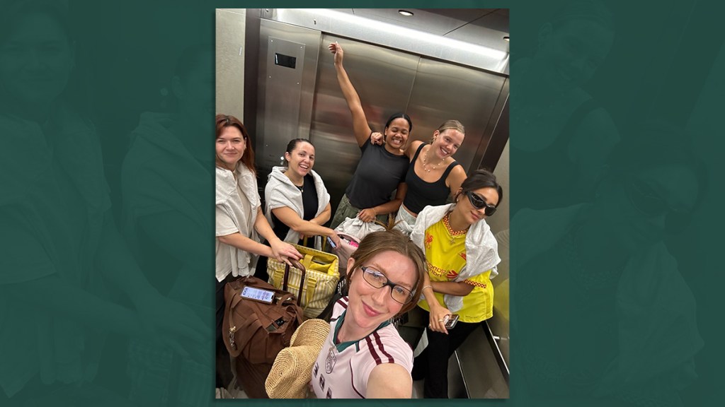 group of people in an elevator taking a photo