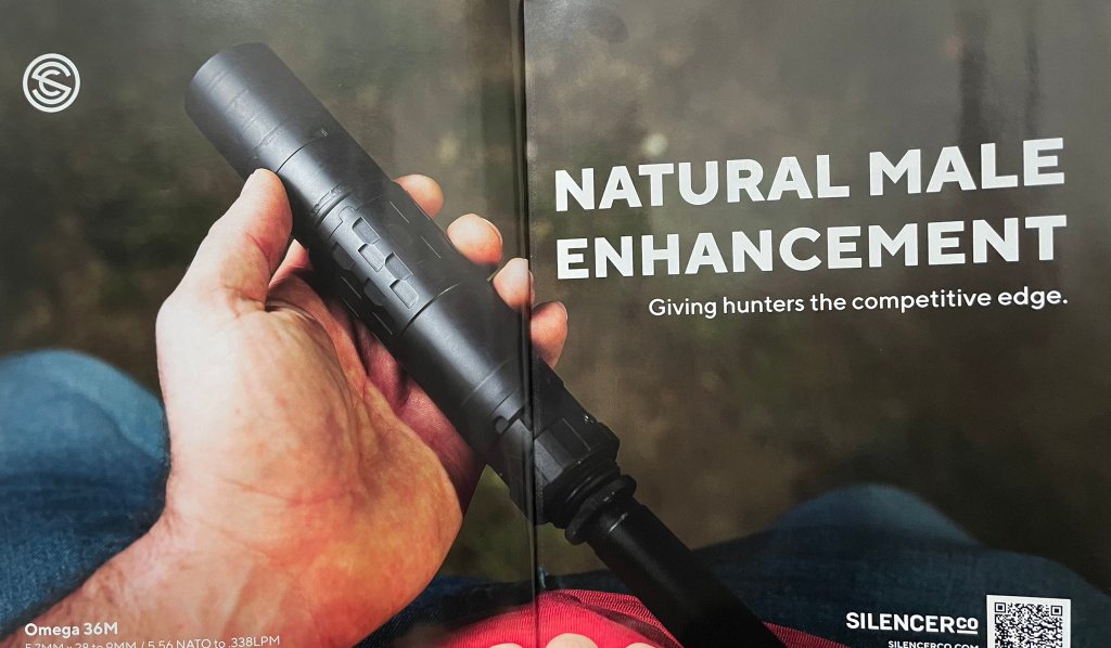 An advertisement showing a firearm with a silencer held in one hand, with the following text: Natural Male Enhancement, giving hunters a competitive advantage.